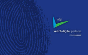 Veitch Digital Partners logo on brand blue with thumbprint signifying their tagline Make it personal