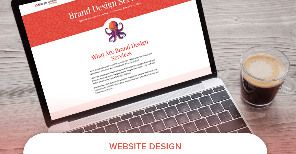 Open laptop displaying a website design page for brand services next to a cup of coffee