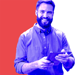 Bearded man using a tablet and smiling, reflecting confidence in strategic brand design solutions.