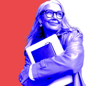 Confident woman holding books and a laptop, representing leadership in strategic brand design.